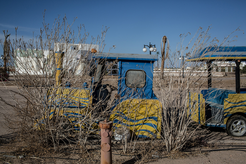 Bushes grow over a hotel novelty train cart at an abandoned hotel (Photo: Chris McGrath/Getty Images)